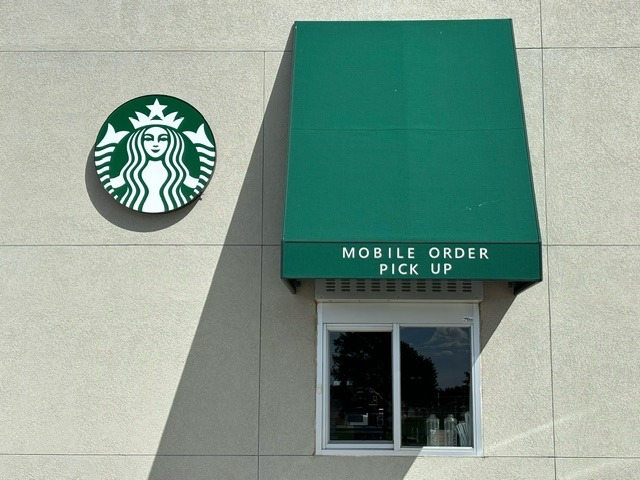 A starbucks sign on the side of a building
