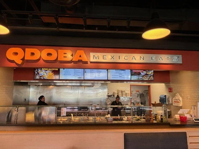 A mexican restaurant with a man behind the counter